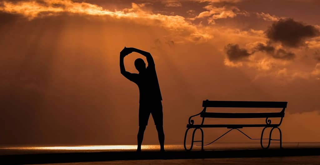 A silhouette of a person exercising