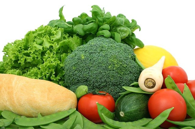 A heap of assorted vegetables that include broccoli and tomatoes