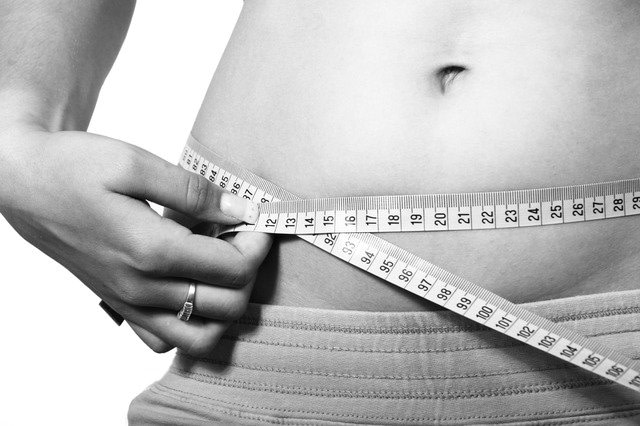 Woman measuring waist circumference 
