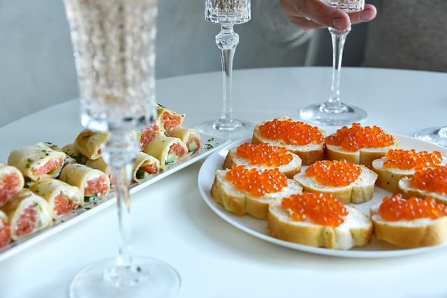 Red caviar sandwiches and rolls in plates 