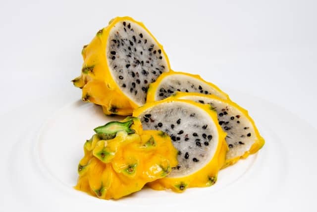 Yellow dragon fruit with white flesh and black seeds 
